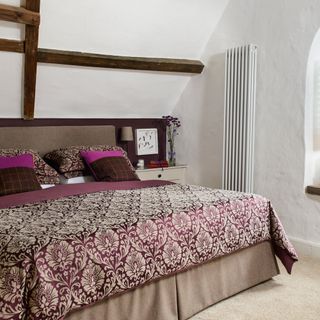 bedroom with white radiator and wall
