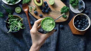 What is keto? Image shows person holding green smoothie