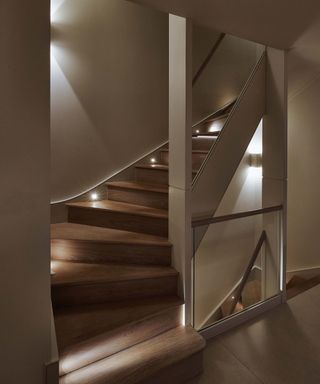Staircase lighting idea with sloped ceiling in Kensington, London townhouse by Sian Parsons at John Cullen Lighting