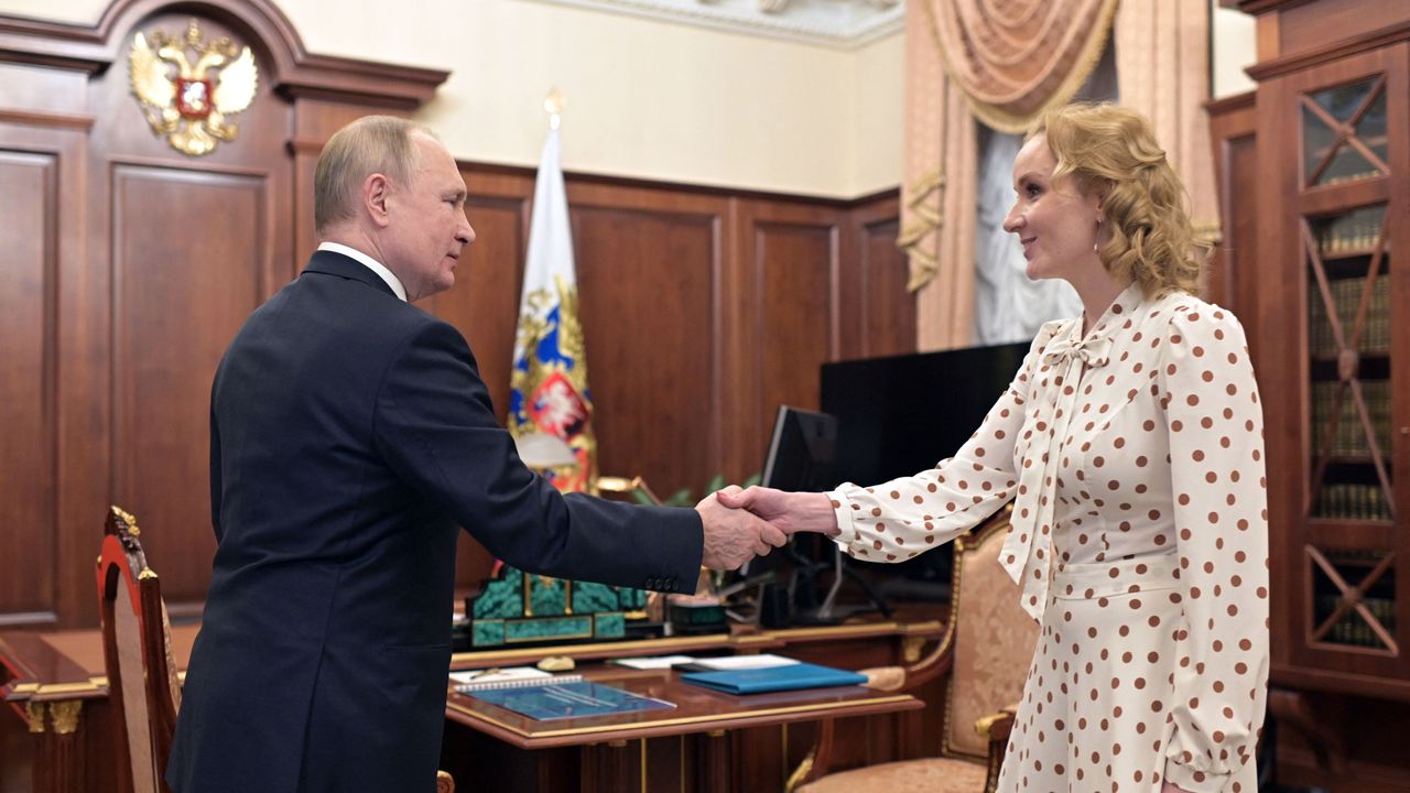 Maria Lvova-Belova and Vladimir Putin shaking hands in the Kremlin