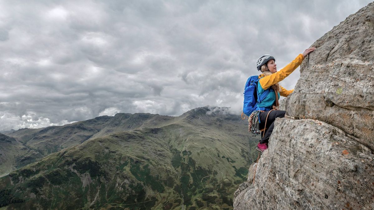 Woman rock climbing in Lake District 