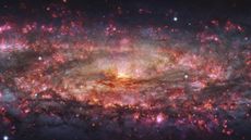 an image of a swirling galaxy in purple and orange shades