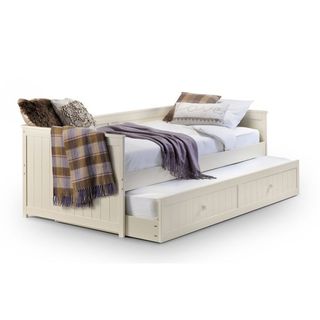 Cream wooden storage bed with white mattresses, pillows and throws