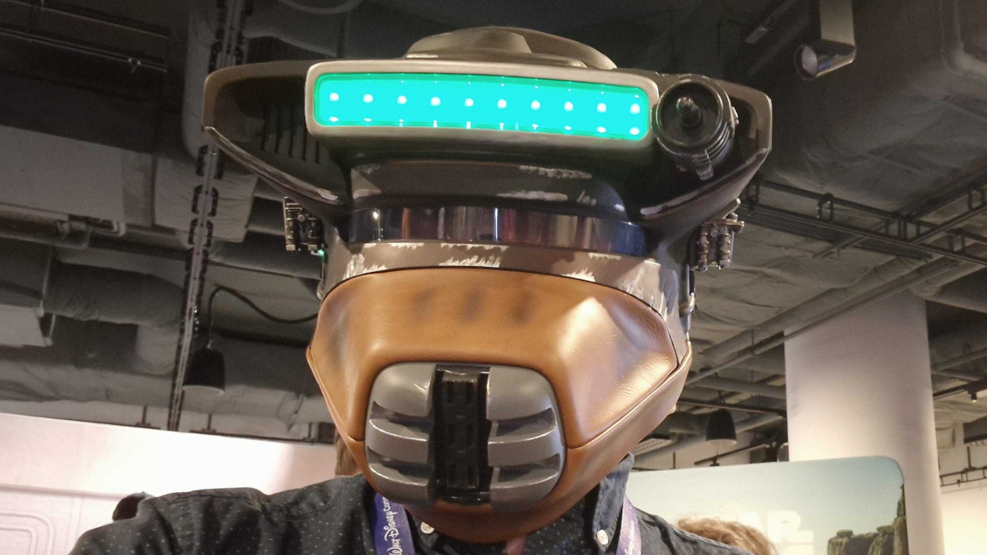 Someone wearing the Boushh replica Star Wars helmet in an industrial-looking room