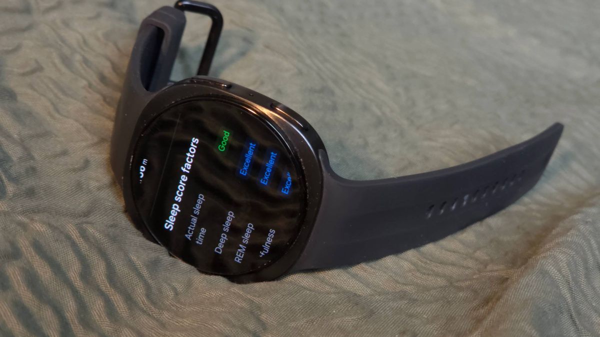 The Samsung Galaxy Watch 9 on a bed, showing sleep data.