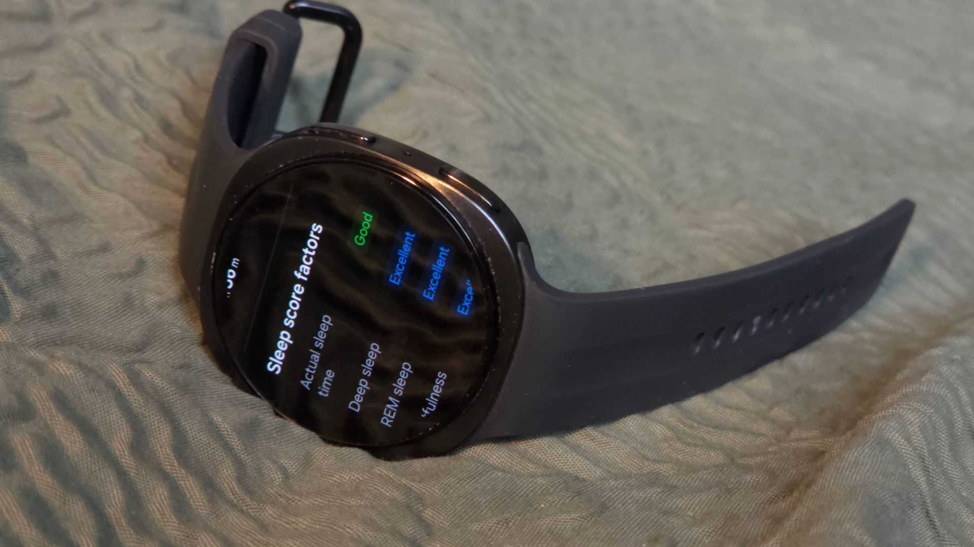 The Samsung Galaxy Watch 9 on a bed, showing sleep data.