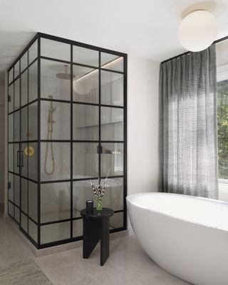 A shower enclosure made of glass and metal