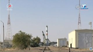 The Soyuz rocket carrying the uncrewed Progress 68 cargo ship is seen just one minute before Russia's Roscosmos space agency aborted a launch attempt from Baikonur Cosmodrome in Kazakhstan on Oct. 12, 2017. One of two umbilical towers (left) had already r