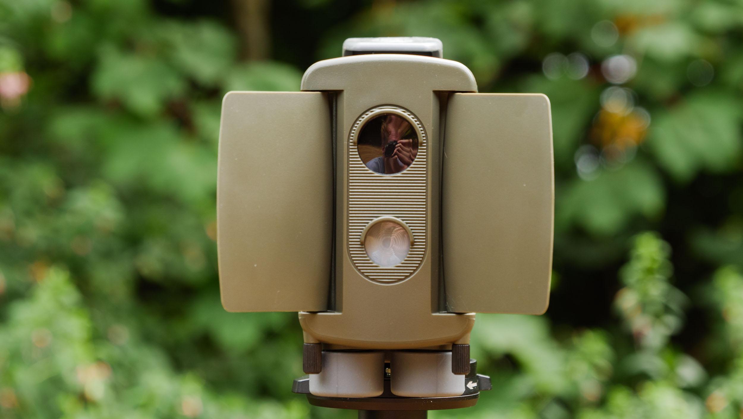 Camtraptions Camera Trap device outdoors with foliage backdrop