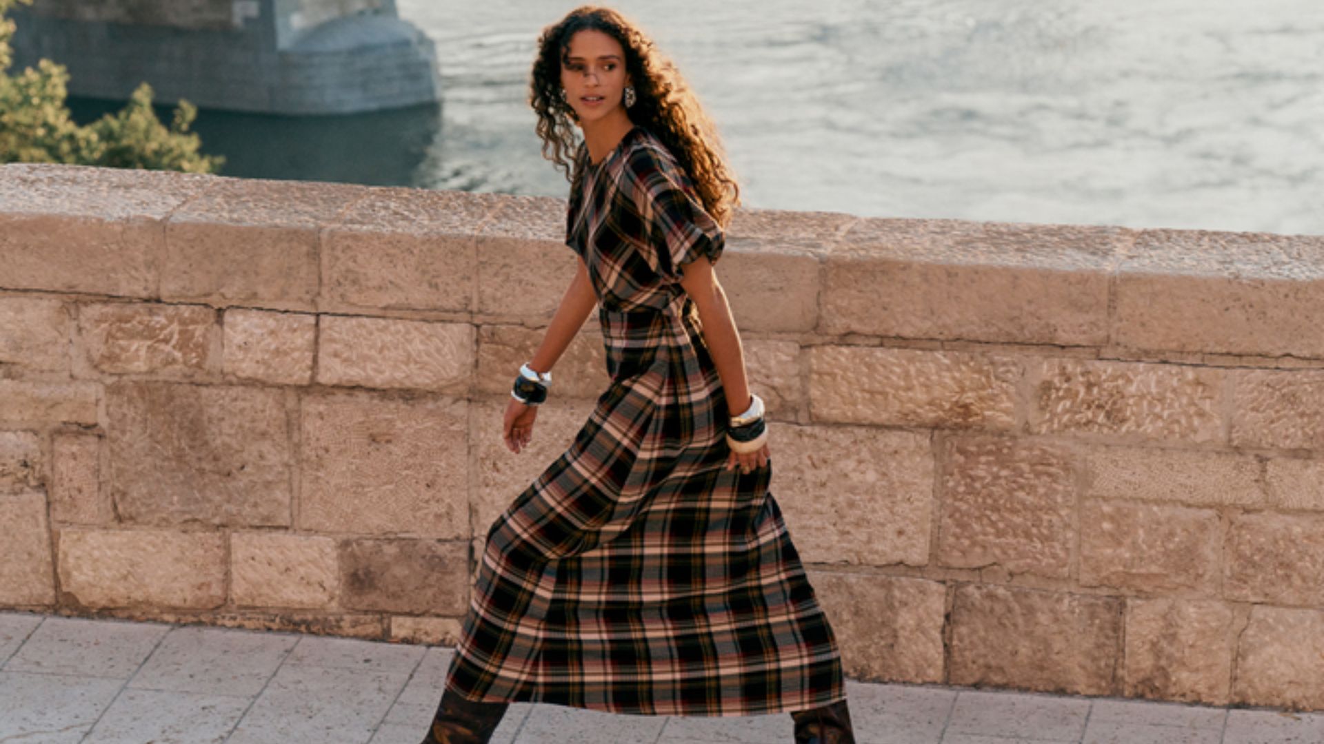A model wearing a check dress from Next