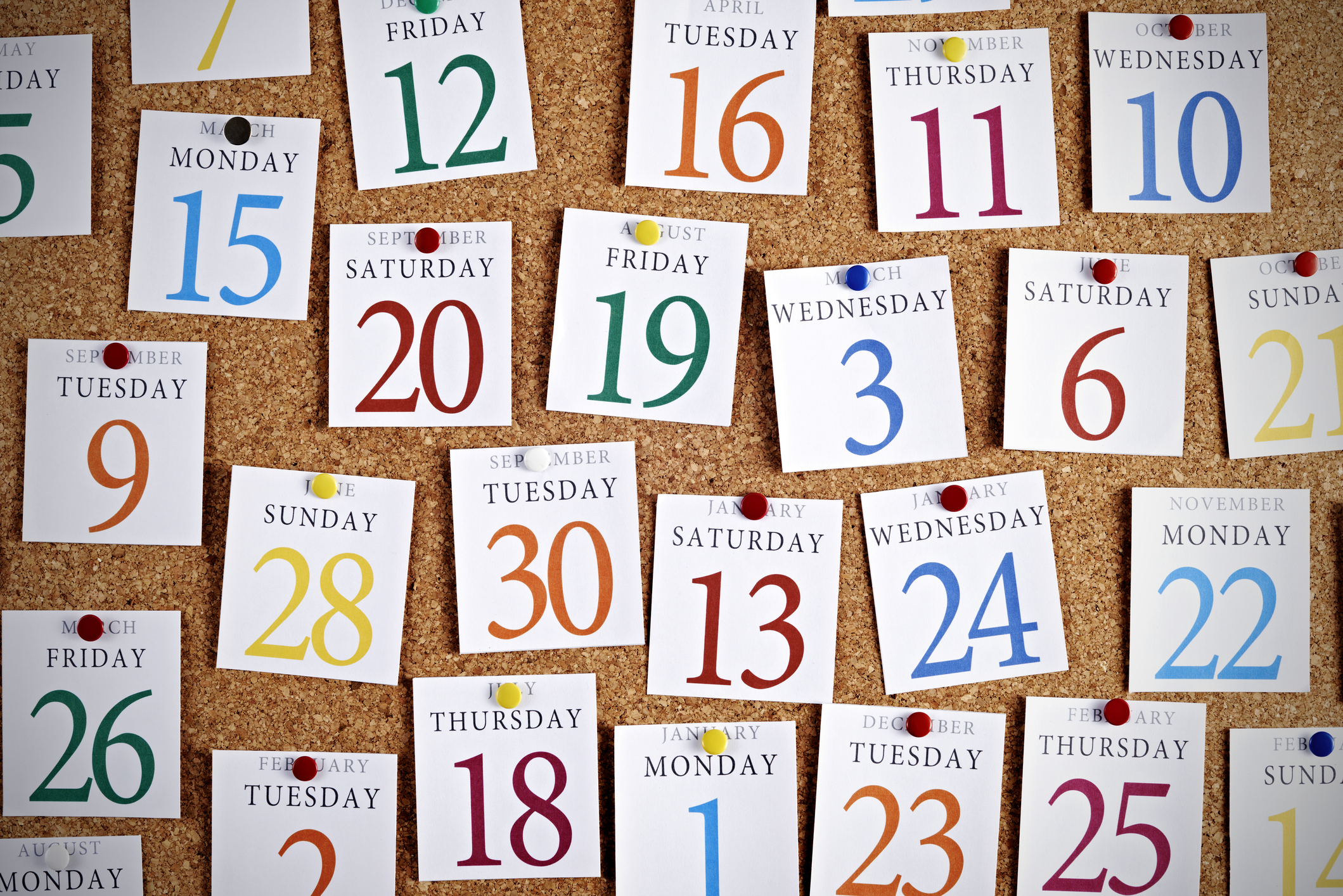 Calendar pages pinned cork board.