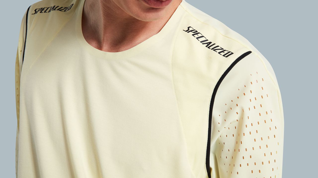 A close up of the ventilation holes on the shoulder of the pastel yellow race jersey