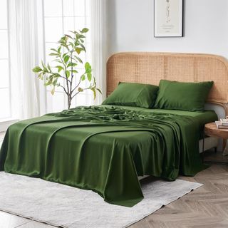 A Sijo Airyweight Eucalyptus Sheet Set in forest green, set up on a bed.