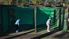 Golfers hitting into nets