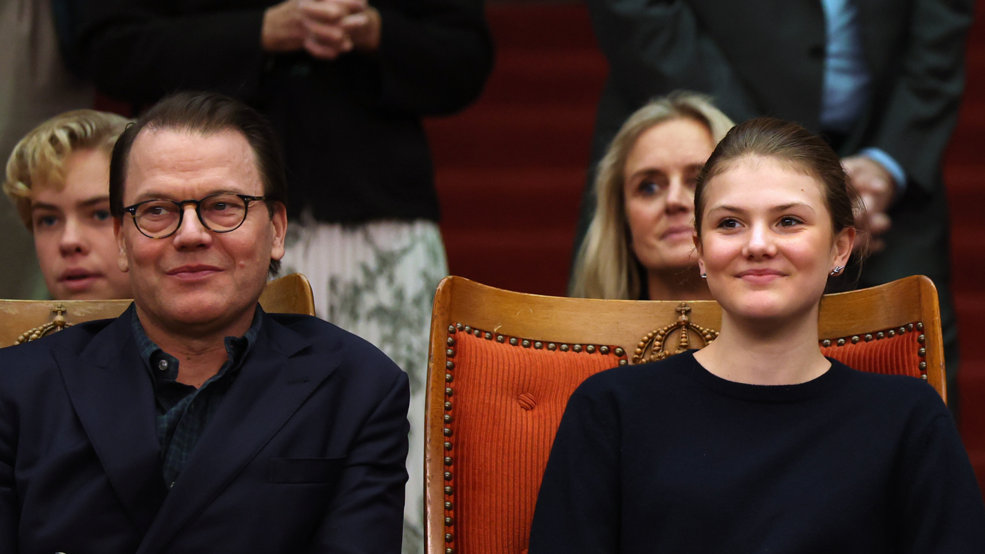 Princess Estelle and Prince Daniel sitting next to each other watching a tennis match