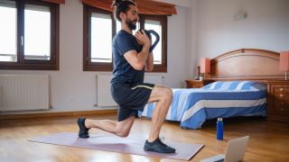 Man performs lunge with kettlebell