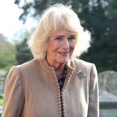 Queen Camilla wears a beige coat with a brooch