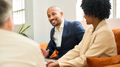 A couple talk to their financial adviser
