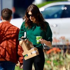 Kaia Gerber walking in Los Angeles with a green juice and cell phone