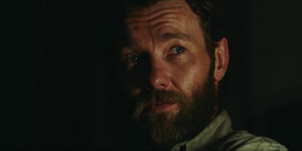 Joel Edgerton smiling in It Comes At Night.