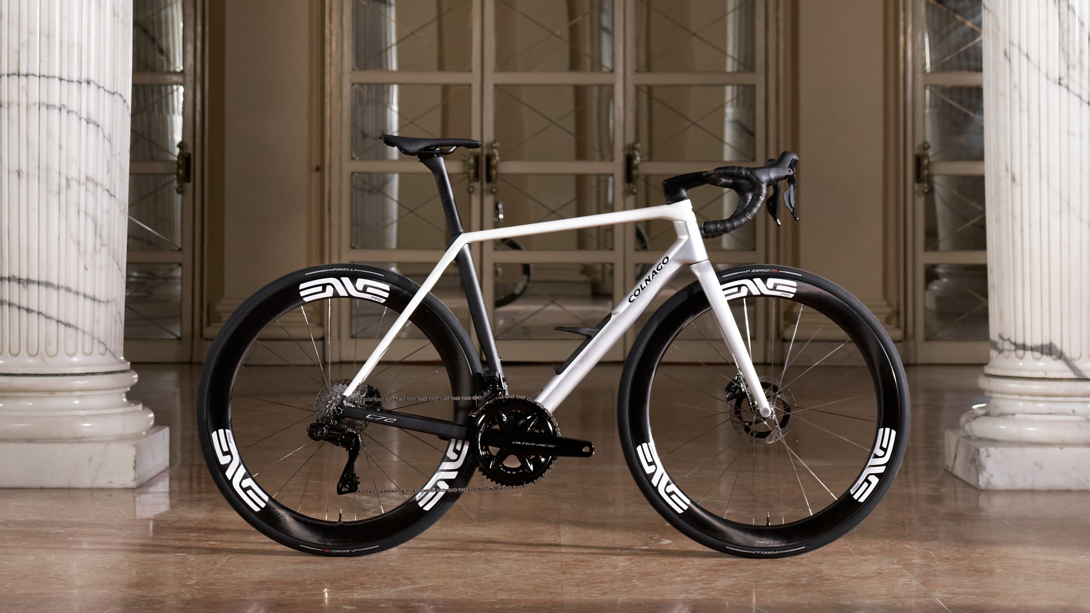 A white and black Colnago C72 between two marble collumn