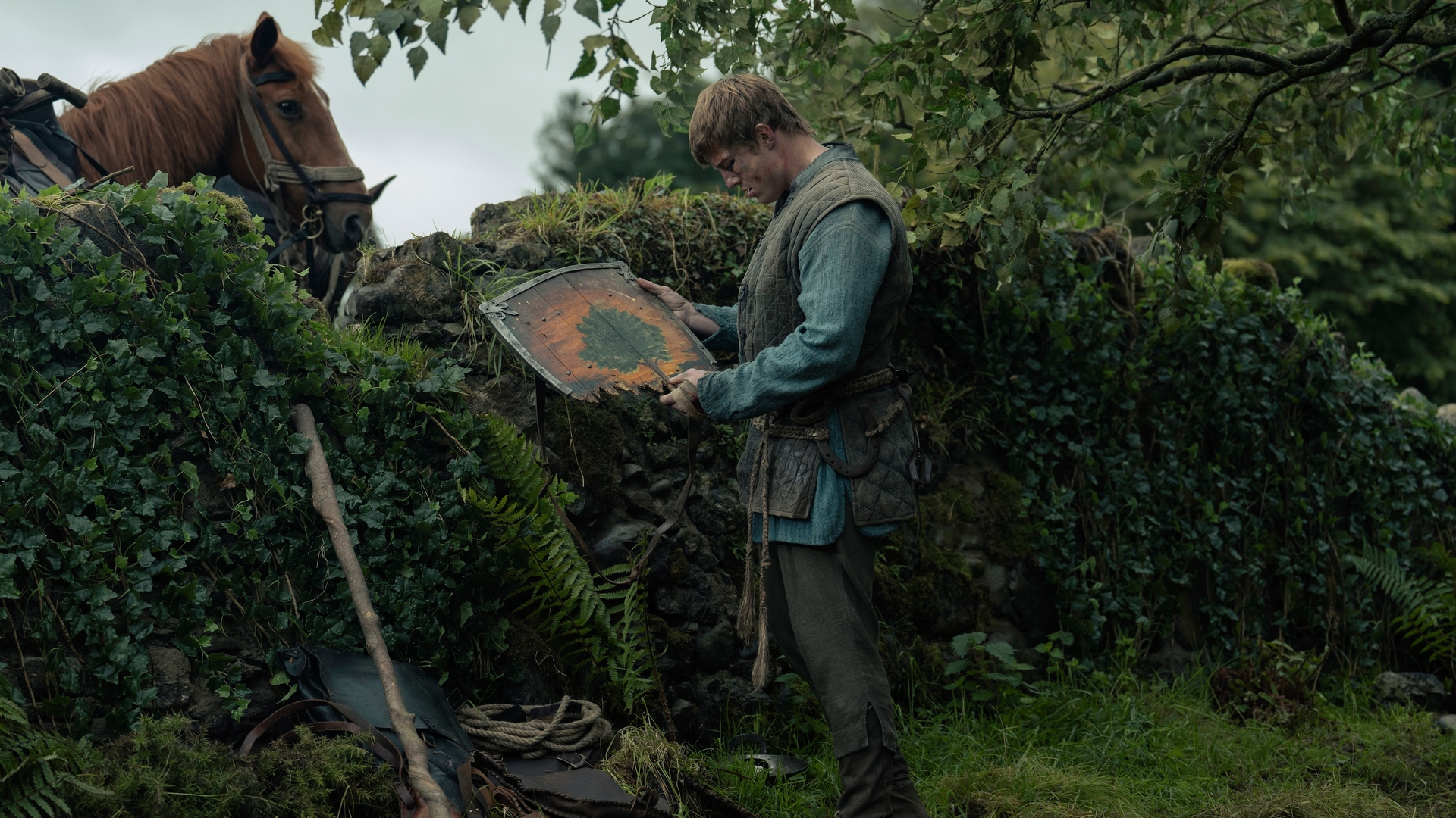 Dunk (Peter Claffey) inspects a shattered shield in a scene from "A Knight of the Seven Kingdoms" episode 6