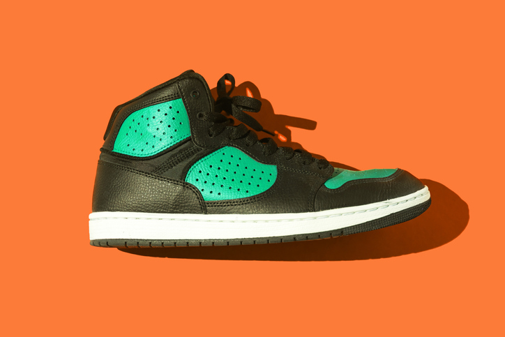 Route One trainer on an orange background