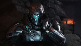 Doom: The Dark Ages Sentinel Barracks secrets and collectibles - A Sentinel soldier with their hand to their helmet while using a laptop.