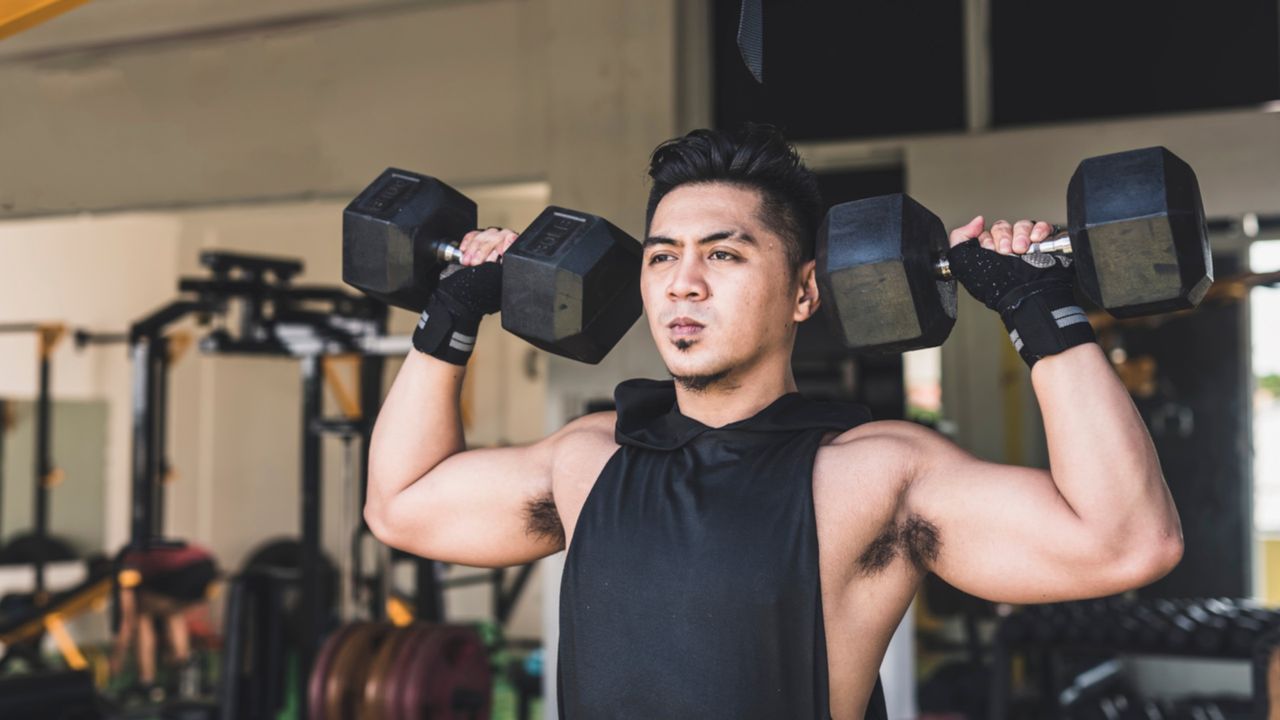 Man doing dumbbell shoulder press