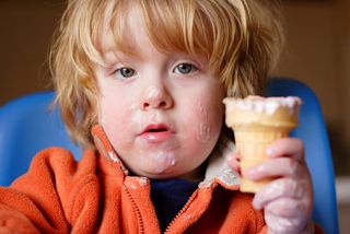 kid eating ice cream on a cone