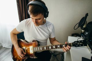 Man recording guitar