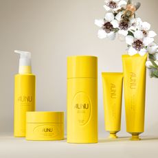 five bright yellow bottles with white flowers