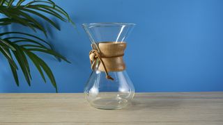 an hourglass coffee maker by Chemex with a 6 cup capacity and a wooden collar with a rawhide tie