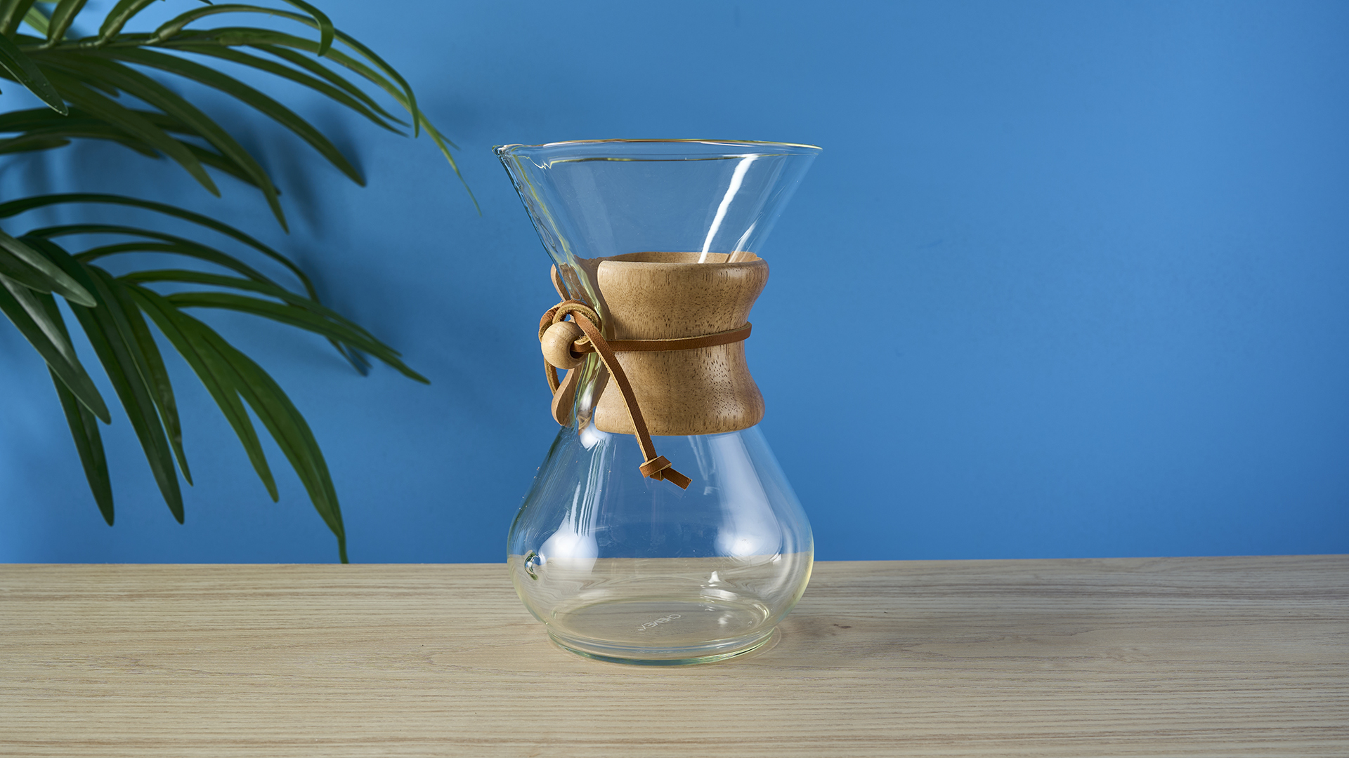 a 6-cup hourglass coffee maker from Chemex and a wooden collar with a rawhide tie