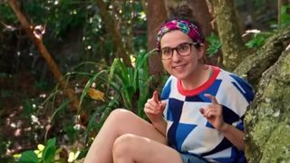 Aubry Bracco talks while sitting in front of a tree on Survivor.