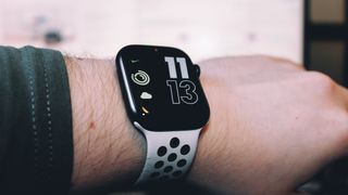 The Apple Watch series 8 with a white strap pictured on someone's wrist.