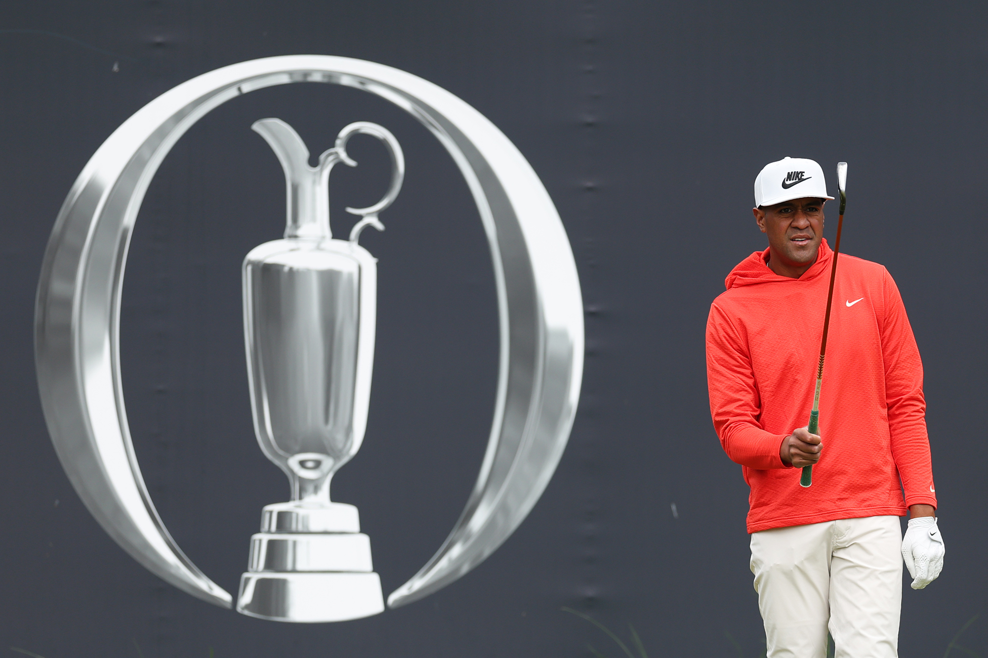 Tony Finau going through his pre-shot routine on the tee, in front of the grandstand with the Open logo, at Royal Portrush during the 153rd Open Championship