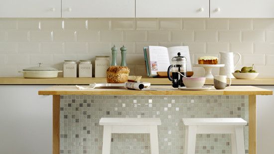 kitchen room with mosaic pattern tiles and white stool