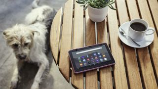 Amazon Fire 7 tablet on a table next to a dog