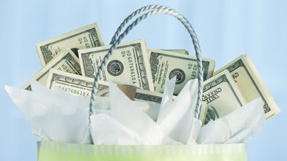 A gift bag is filled with twenty-dollar bills.