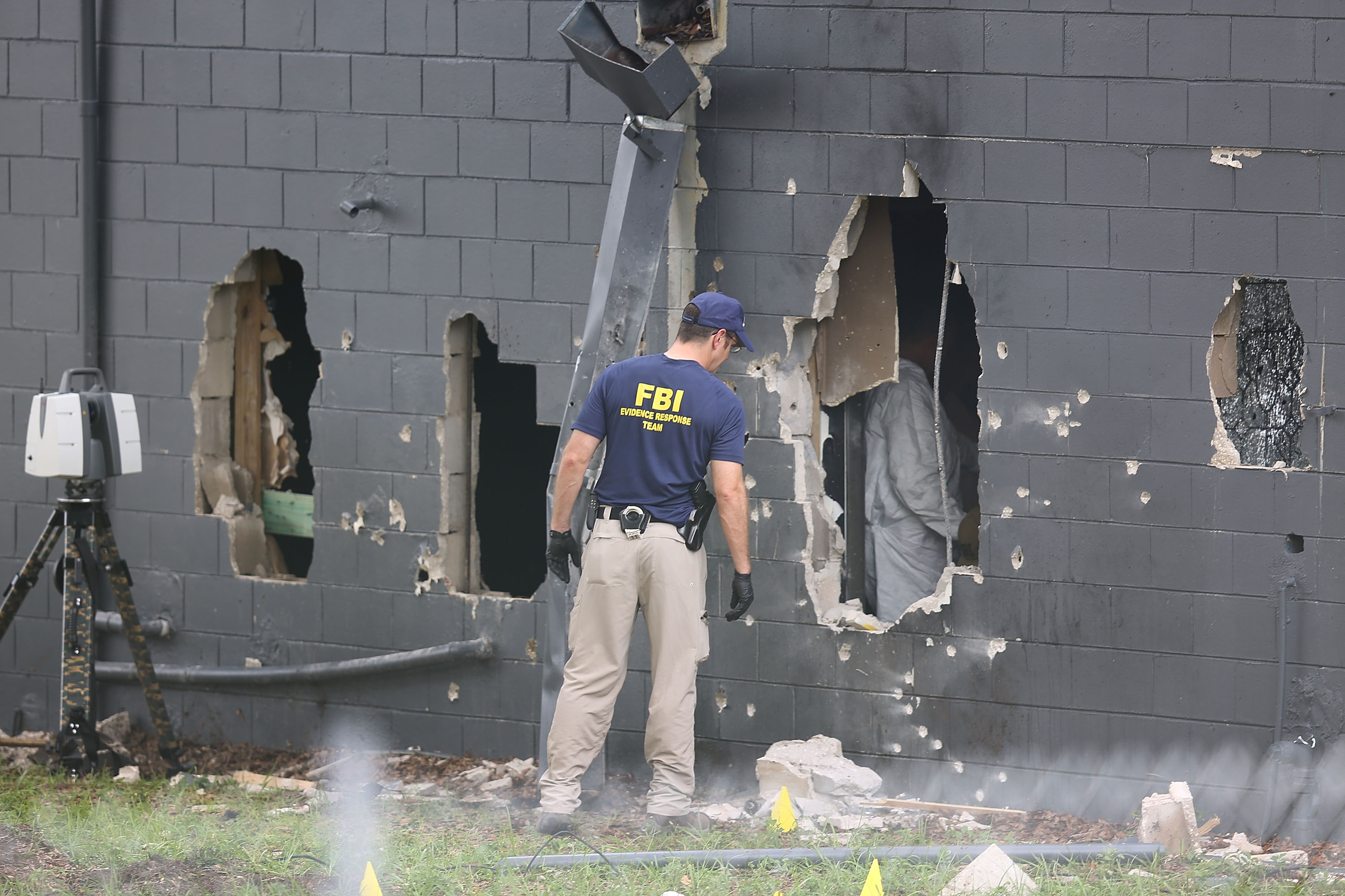 FBI officials investigate the Pulse nightclub following Sunday's mass shooting