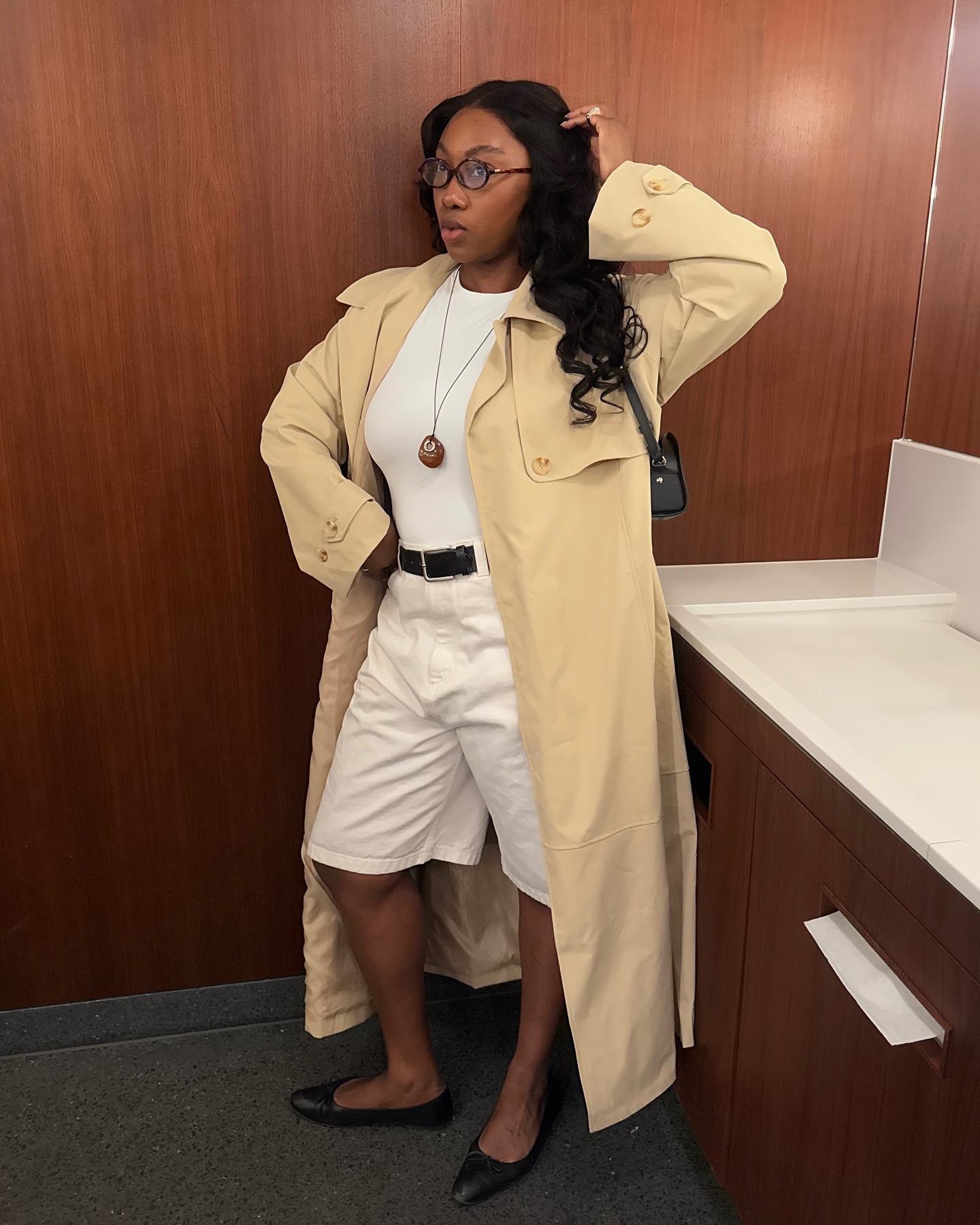 @nnennaechem wears white denim Bermuda shorts with a pair of black leather ballet flats
