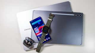 Samsung ecosystem of devices including the Galaxy S25 Ultra, Galaxy Watch Ultra, Buds 3 Pro, Samsung laptop, and Tab S10 Ultra