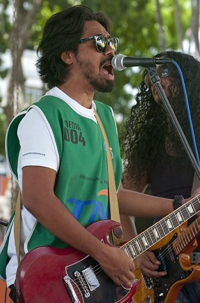 The lead singer of a local rock band got in on the act wearing this writer's photographer's bib whilst performing at the finish in Pandan Indah.