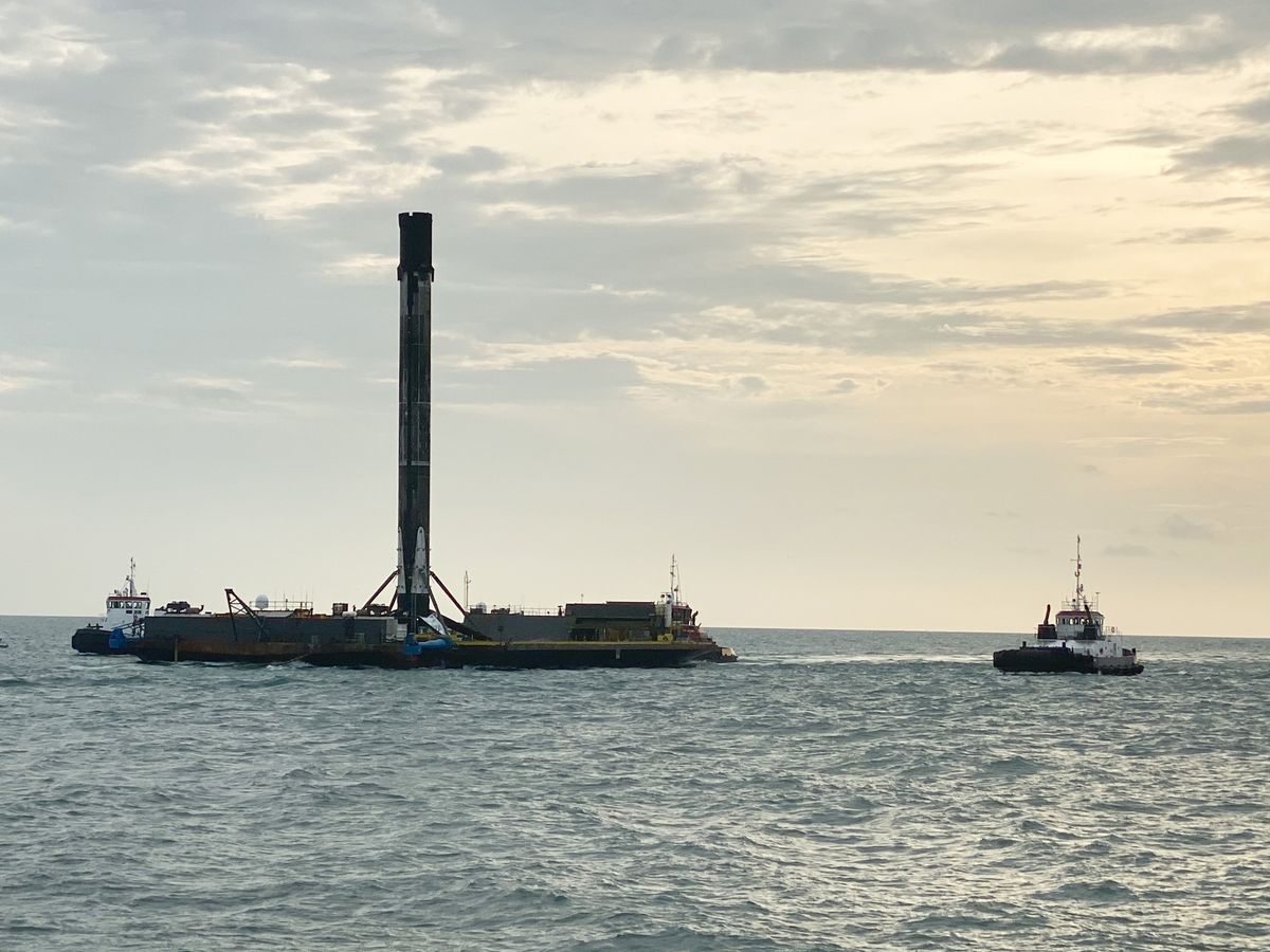 SpaceX's first Falcon 9 booster to fly six times returns home to Port Canaveral in Cape Canaveral, Florida on Aug. 21, 2020 atop the drone ship landing platform Of Course I Still Love You. The rocket launched 58 Starlink satellites and three Planet SkySats from Cape Canaveral Air Force Station on Aug. 18.