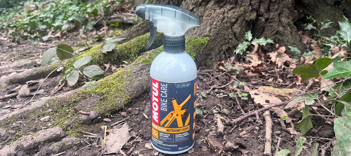 Motul Frame Clean bottle on ground by tree