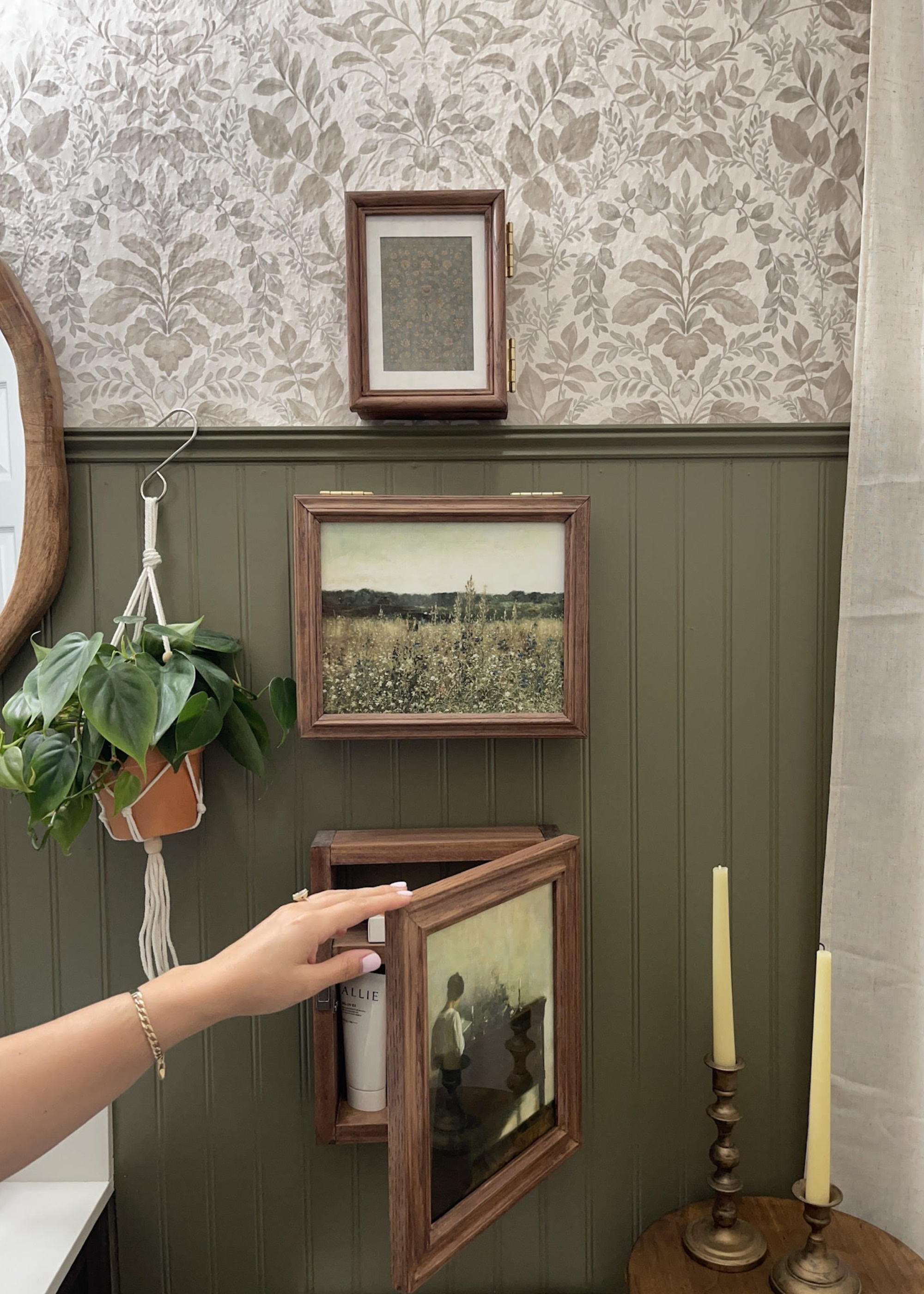 A bathroom with framed art storage mounts