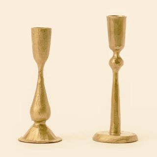 Antique Brass Taper Candle Holder against a cream background.