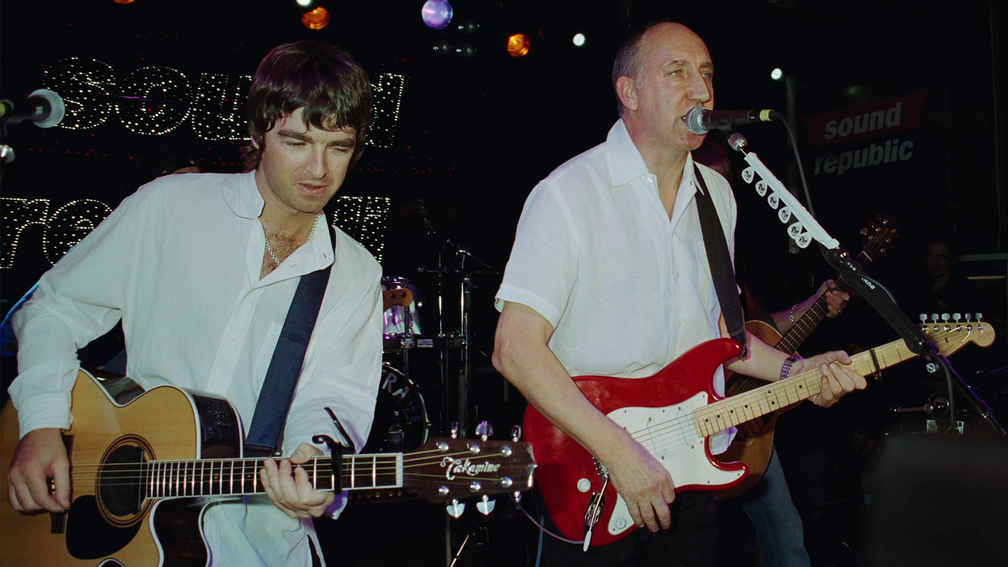 English musicians Noel Gallagher (left) and Pete Townshend performing on stage during the opening night for the 'Sound Republic' music venue, London, 15th October 1998.