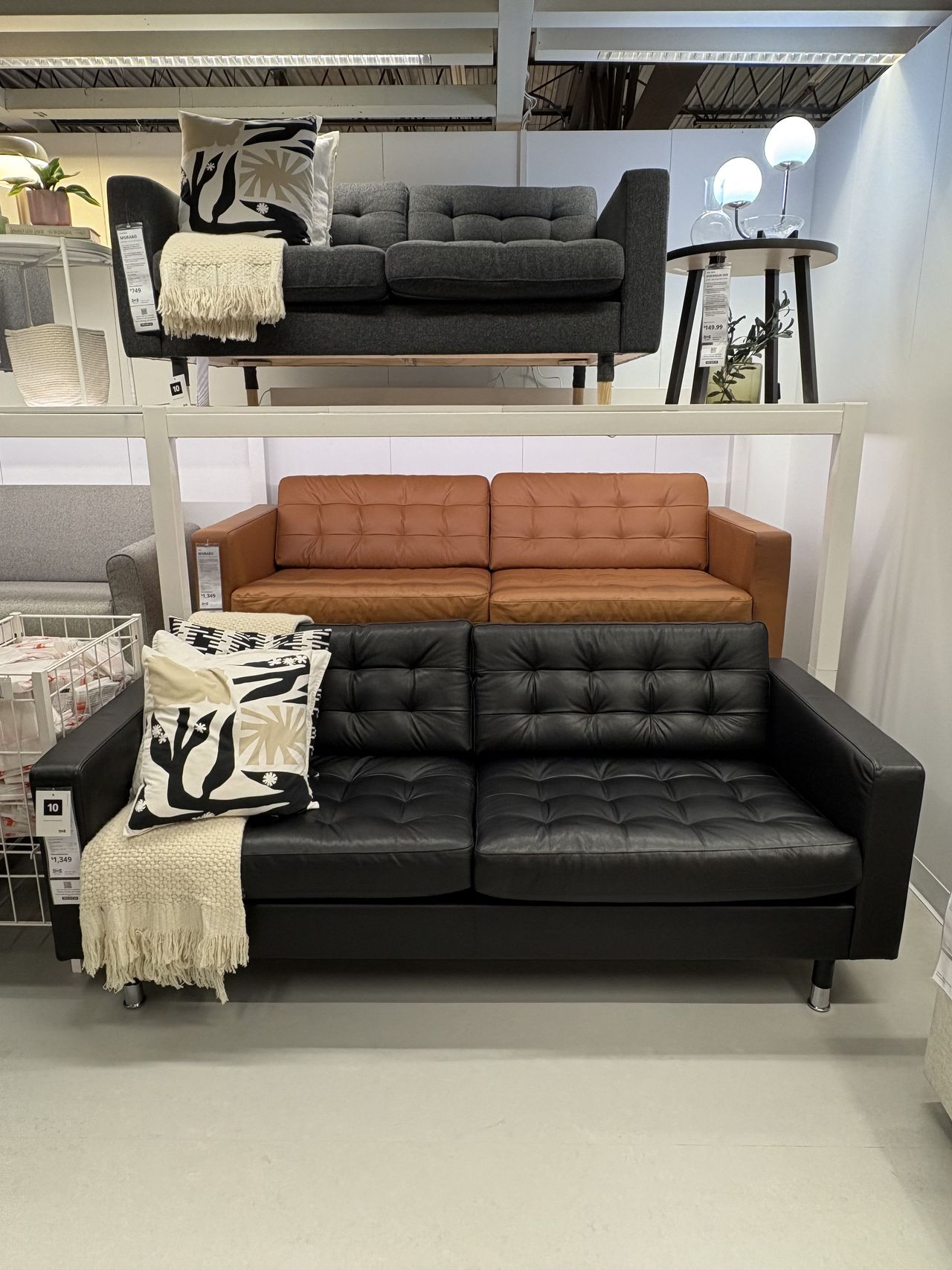 a black leather sofa in an IKEA showroom.